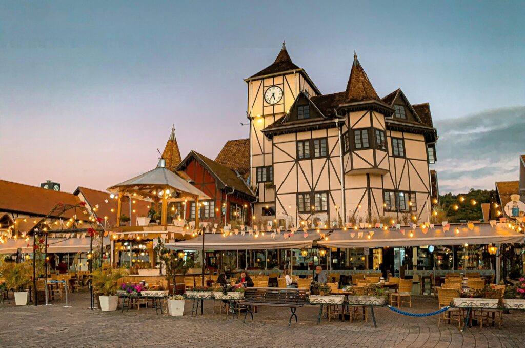 Beautiful twilight scene at Parque Vila Germânica in Blumenau, showcasing charming architecture and outdoor dining.